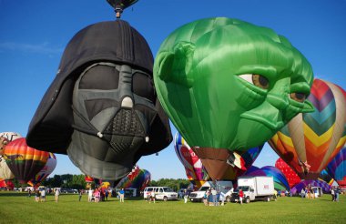 SOLBERG AIRPORT-READINGTON, NEW JERSEY, USA-JULY 25, 2015: Seen at the 2015 Quick Chek New Jersey Festival of Ballooning were two of the most popular characters from STAR WARS depicted as hot air balloons, Darth Vader and Master Yoda. clipart