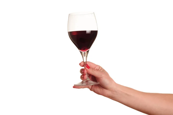 Vrouwelijke hand met rode wijnglas — Stockfoto