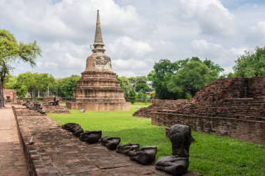 Old ruined buddhist temples and Palace in a green forest park in Ayutthaya landmark, Thailand