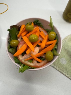 Akdeniz salatası havuç, domates ve zeytinlerle hazırlandı.