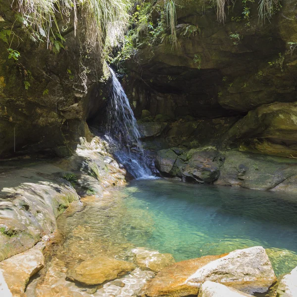 Waterfall on a blue turquoise pond in Isalo, Madagascar