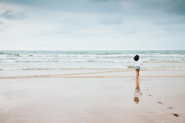 Fille profiter de la plage avec le mauvais temps — Photo