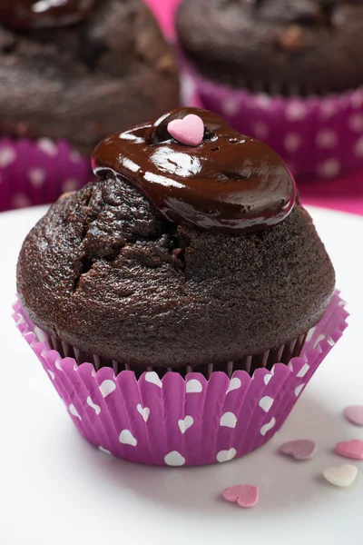 Chocolate muffins with melted chocolate and heart topping — Stock Photo, Image