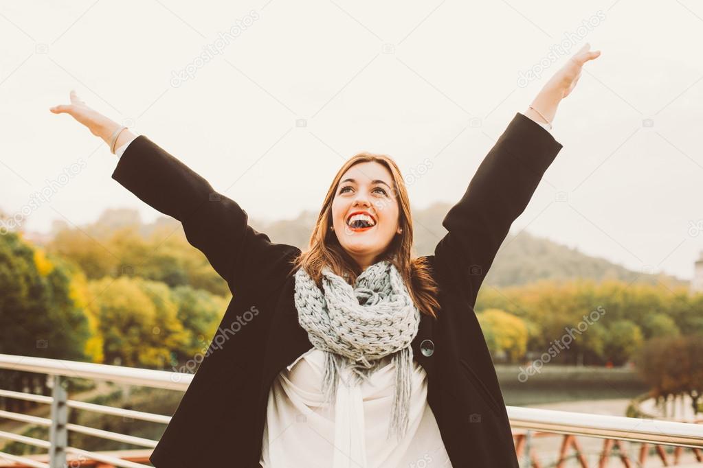 Happy woman raising arms