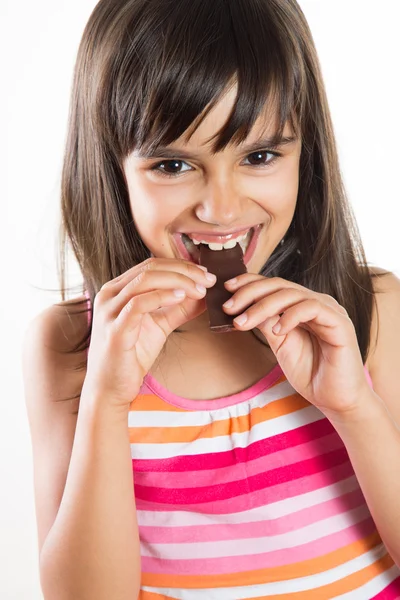 Funny little girl eating chocolate — Stock Photo, Image