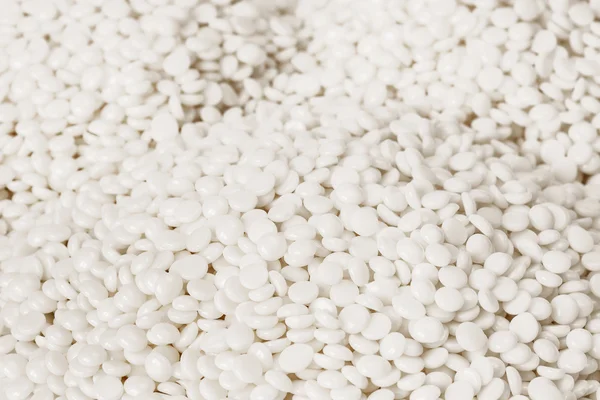 Fine white polymer granules — Stock Photo, Image