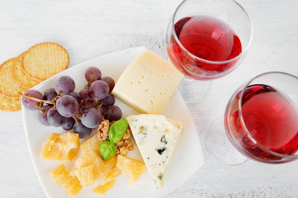 Cheese platter and two glasses of red wine