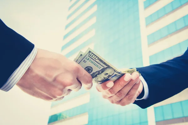 Hands of businessmen passing money — Stock Photo, Image