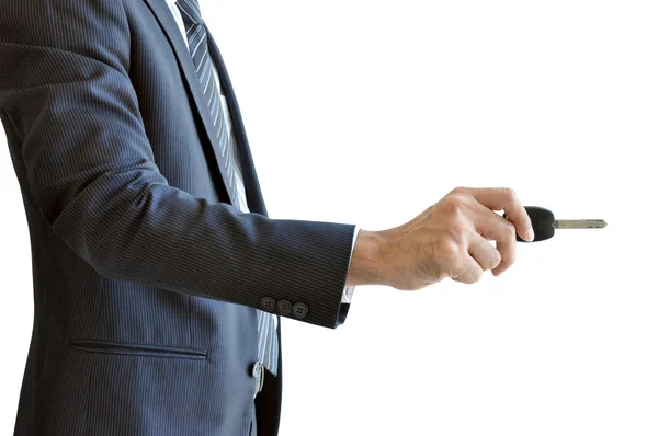Businessman hand holding a car key - unlock action — Stock Photo, Image