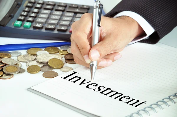 Hand pointing to Investment word on the paper — Stock Photo, Image