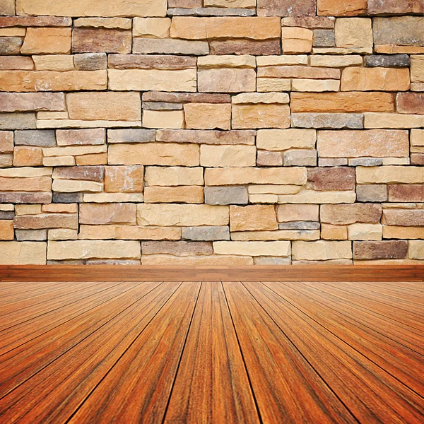 Dřevěná podlaha s kamennou zdí — Stock fotografie