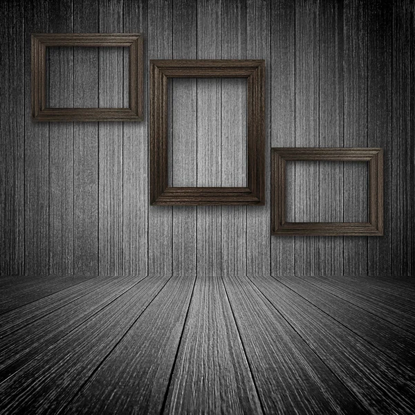 Wooden photo frames on the wall inside the room — Stock Photo, Image