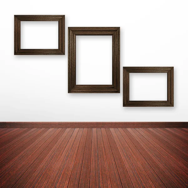 Wooden picture frames on the wall inside the room — Stock Photo, Image