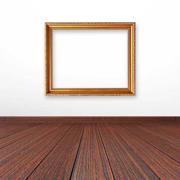 Golden picture frame on the wall inside the room — Stock Photo, Image