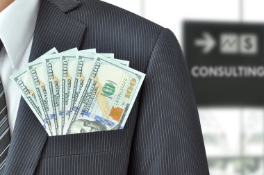 Dollar banknotes in pocket of businessman's suit