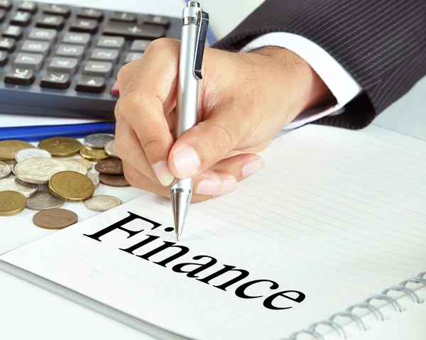 Hand pointing to Finance word on the paper — Stock Photo, Image