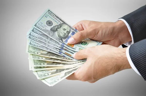 Zakenman handen met Dollars — Stockfoto