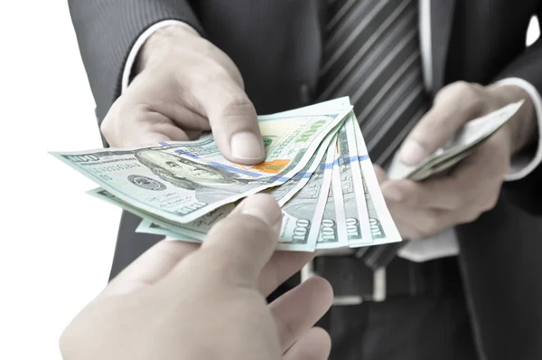Hand giving money to another person — Stock Photo, Image