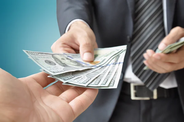 Hand receiving money from businessman — Stock Photo, Image