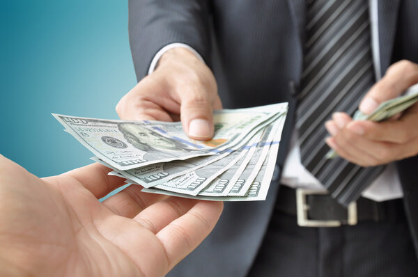 Hand receiving money from businessman