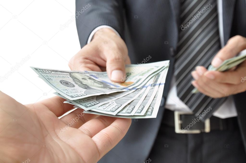 Hand giving money to another person