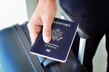 Hand holding U.S. passport clipart