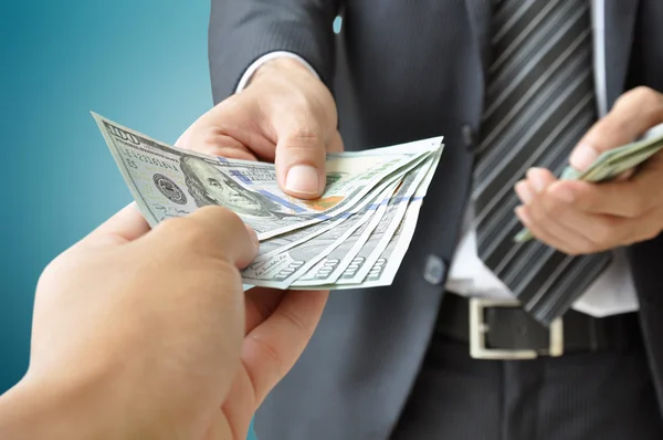 Hand receiving money from businessman — Stock Photo, Image