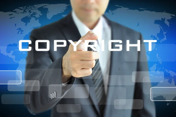Podnikatel, ukazující na Copyright slovo — Stock fotografie