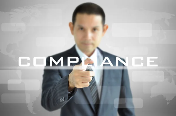 Geschäftsmann verweist auf Compliance-Wort — Stockfoto