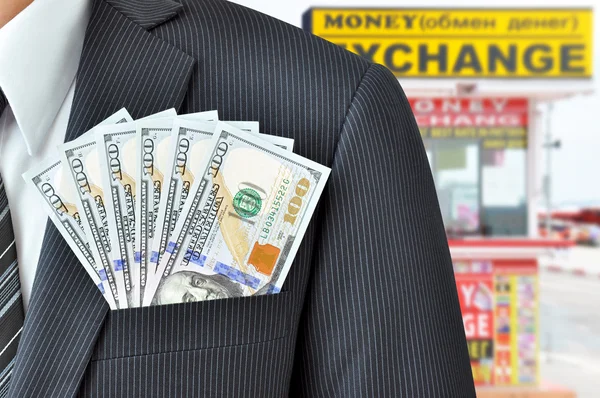 Money (US dollar bills) in businessman pocket - money exchange concept — Stockfoto