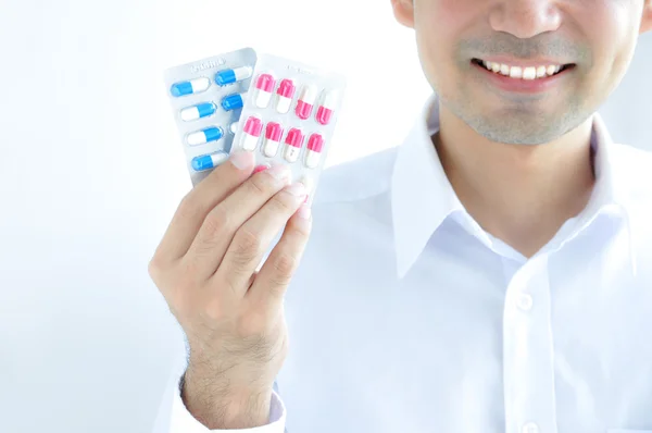 A man holding medicines - blister packs of capsules or pills — Φωτογραφία Αρχείου