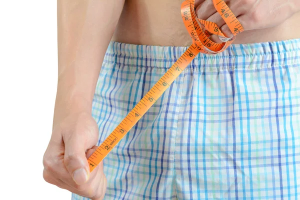 Young man holding tape measure, measuring his penis — Stock Photo, Image