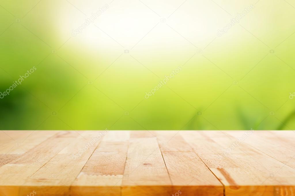 Wood table top on abstract nature green background — Stock Photo
