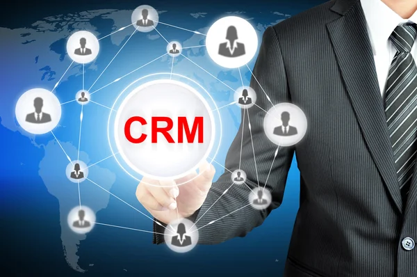 Empresario señalando en CRM (Gestión de Relaciones con el Cliente) signo — Foto de Stock