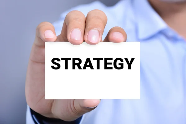 A man showing card with STRATEGY word on it — Stock Photo, Image
