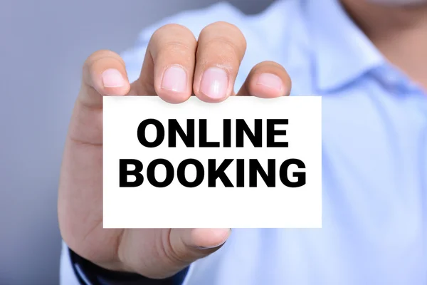 ONLINE BOOKING, message on the card held by a man hand — Stock Photo, Image