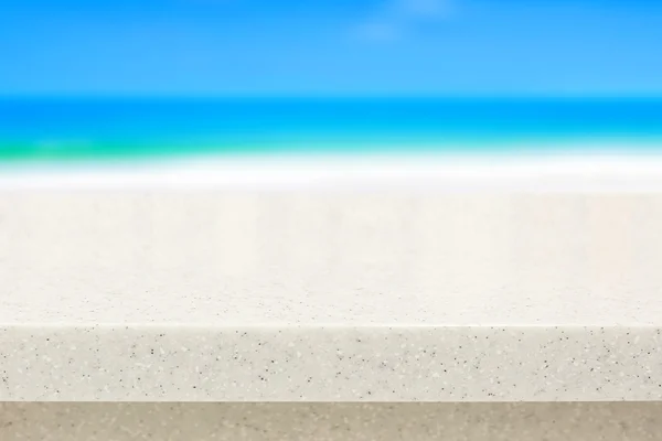 Encimera de piedra blanca sobre fondo borroso de playa — Foto de Stock