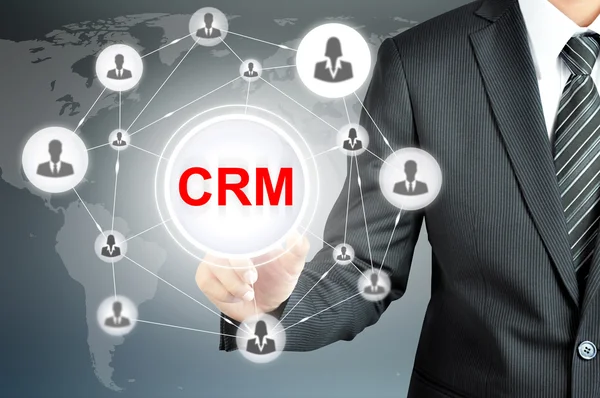 Geschäftsmann zeigt auf crm (Customer Relationship Management) -Schild auf virtuellem Bildschirm — Stockfoto