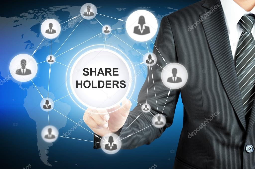 Businessman pointing on SHAREHOLDERS sign on virtual screen