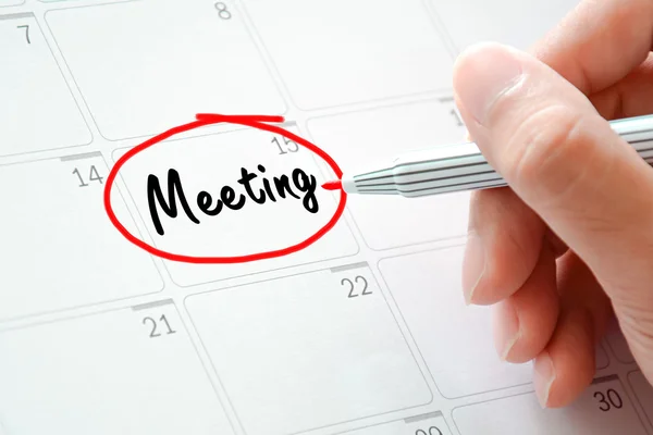 Texto de la reunión en el calendario (o planificador de escritorio) con marcador rojo —  Fotos de Stock