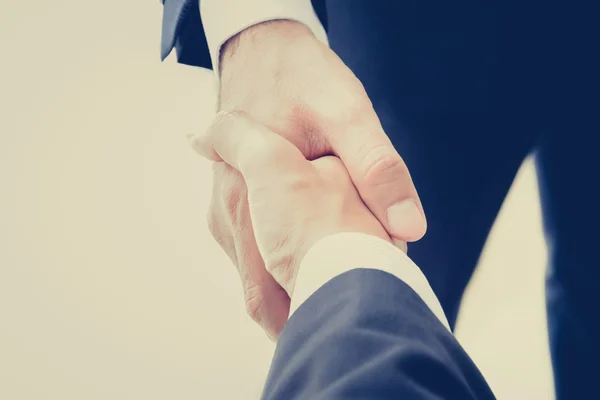 Handshake of businessmen in vintage tone — Stock Photo, Image