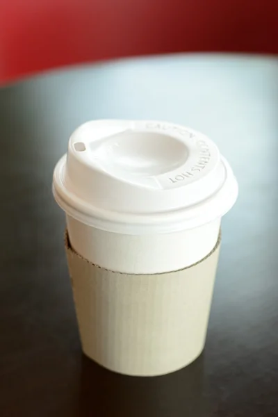 Заберіть чашку кави на столі м'який фокус — стокове фото