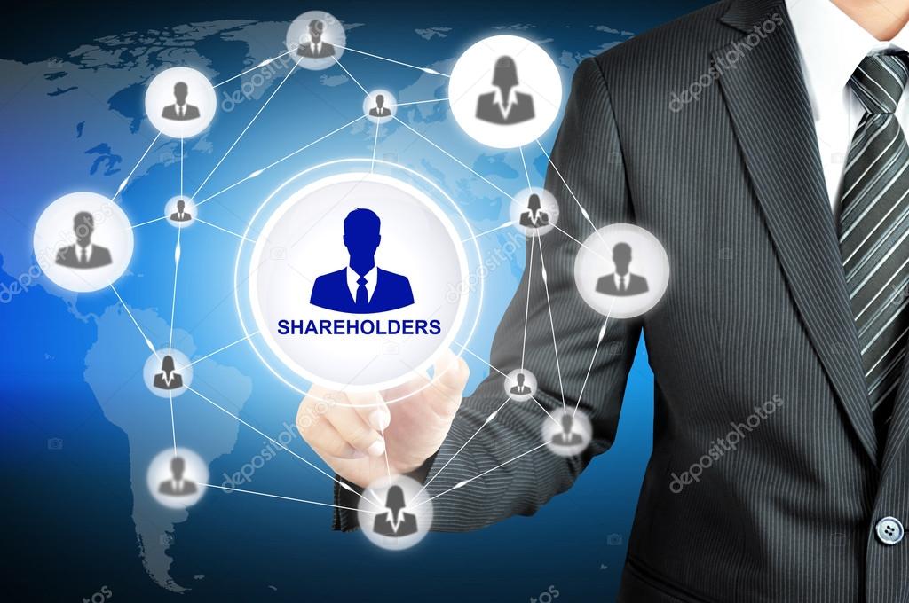 Businessman pointing on SHAREHOLDERS sign on virtual screen with people icons linked as network