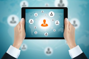 Businessman hands holding tablet pc with businesspeople icons linked as network