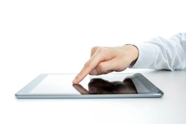 Hand touching tablet pc screen on the table
