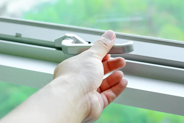 Hand holding glass window latch lever — Stock Photo, Image