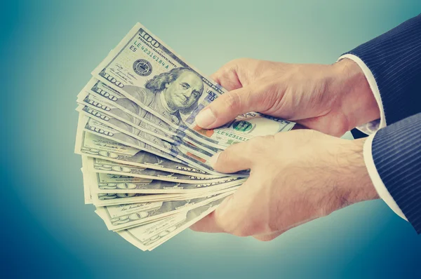 Businessman hands holding money, US dollars (USD) — стокове фото