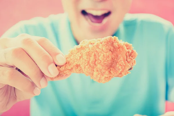 A man with opening mouth about to eat deep fried chicken leg — Stockfoto