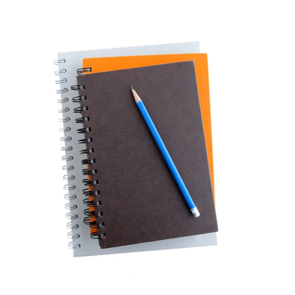 Stack of notebooks (or copybooks) with a pencil - isolated on white background — Stock Photo, Image