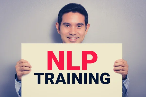 Nlp training, Botschaft auf weißem Karton, gehalten von lächelndem Mann — Stockfoto